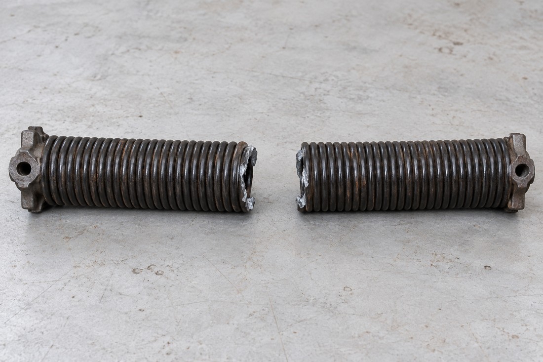 Broken garage door torsion spring split into two sections
